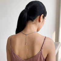 Thumbnail for Back of the neck of a woman with a dark ponytail showing the clasp and extension chain of the silver clover photo necklace | SKU: TPH-CLVN-SILVER
