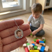 Thumbnail for Customer photo: the silver octagon necklace with her son's photo, her son in the background | SKU: TPH-OCTN-SILVER