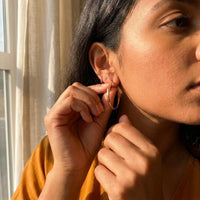 Thumbnail for Diamond Cut Statement Hoops in Gold, being put on | SKU: 41009-gold