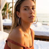 Thumbnail for Diamond Cut Statement Hoops in Gold, worn at a beach club at sunset | SKU: 41009-gold