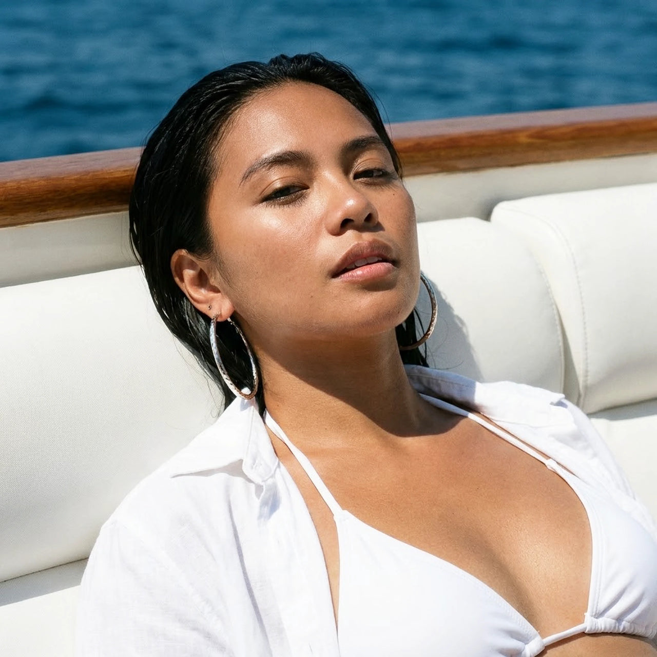 Diamond Cut Statement Hoops in Silver, worn on a yacht | SKU: 41009-silver