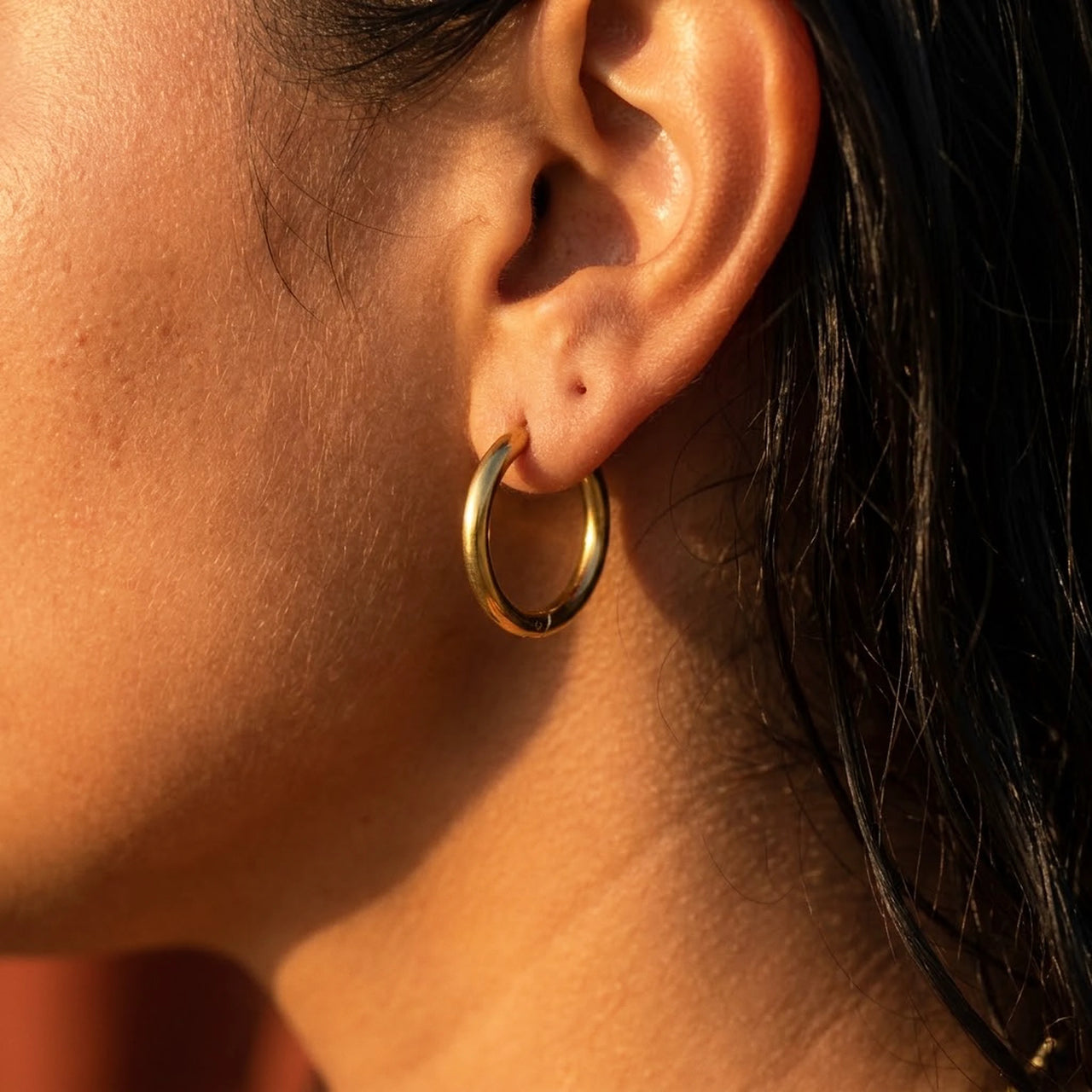 Everyday Waterproof Hoops in Gold, close-up on the earlobe | SKU: 41001-gold