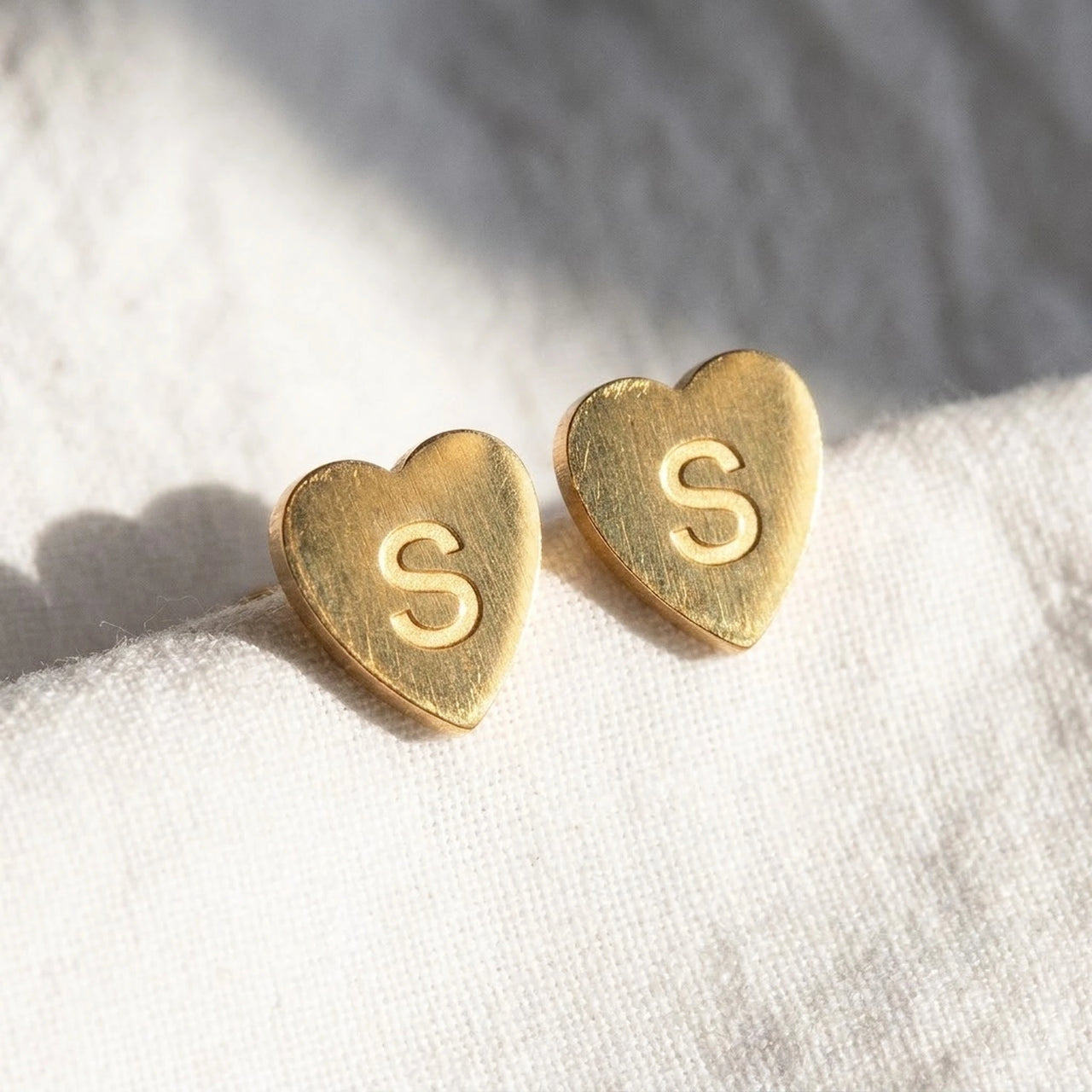 Heart Initial Stud Earrings in Gold, macro detail of the metal and the finish | SKU: heart-initial-gold-a