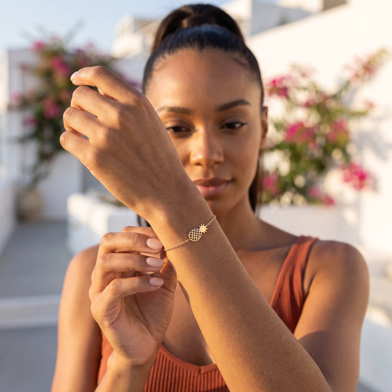 Woman gently touching her gold charm bracelet | SKU: 9178613-gold
