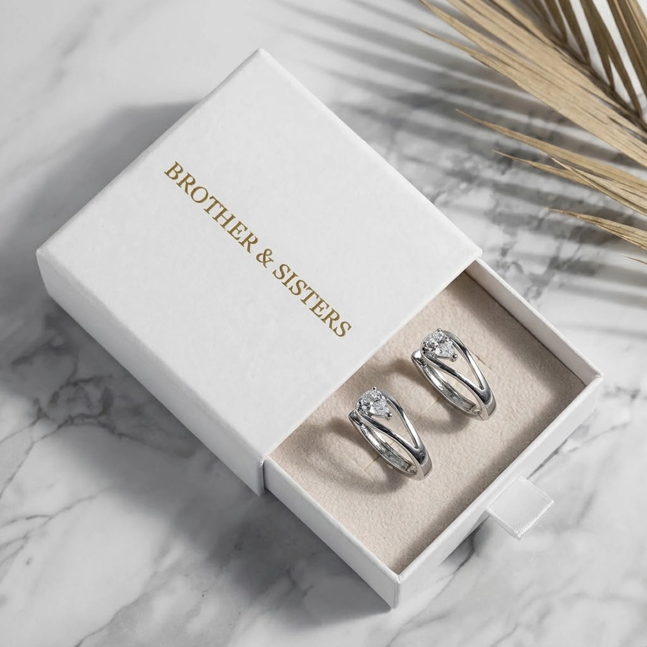 Pear Crystal Huggie Hoops in Silver, in the gift box | SKU: 41007-silver