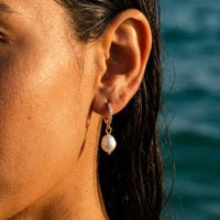 Thumbnail for Pearl Drop Huggie Hoops in Gold, close-up on the earlobe | SKU: 41003-gold