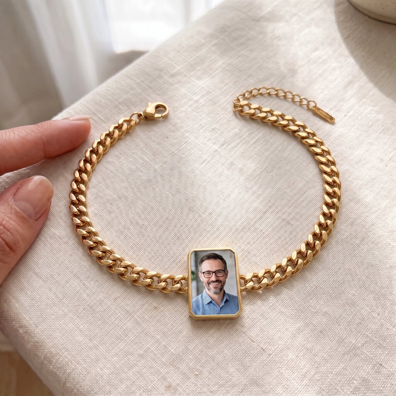 The gold cushion-cut photo bracelet laid flat, shown open with its lobster clasp and extender, her father's photo in the charm | SKU: TPH-CUSB-GOLD