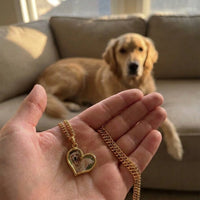 Thumbnail for Customer photo: the gold secret heart necklace with her dog's photo, her dog in the background | SKU: TPH-HRTN-GOLD
