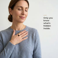 Thumbnail for Woman holding the black heart pendant against her chest, only she knows the photo inside | SKU: TPH-HRTN-GOLD