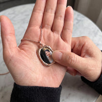 Thumbnail for Thumb warming the rose gold oval pendant: the hidden photo appears under the thumb while the rest stays black | SKU: TPH-OVLN-ROSEGOLD