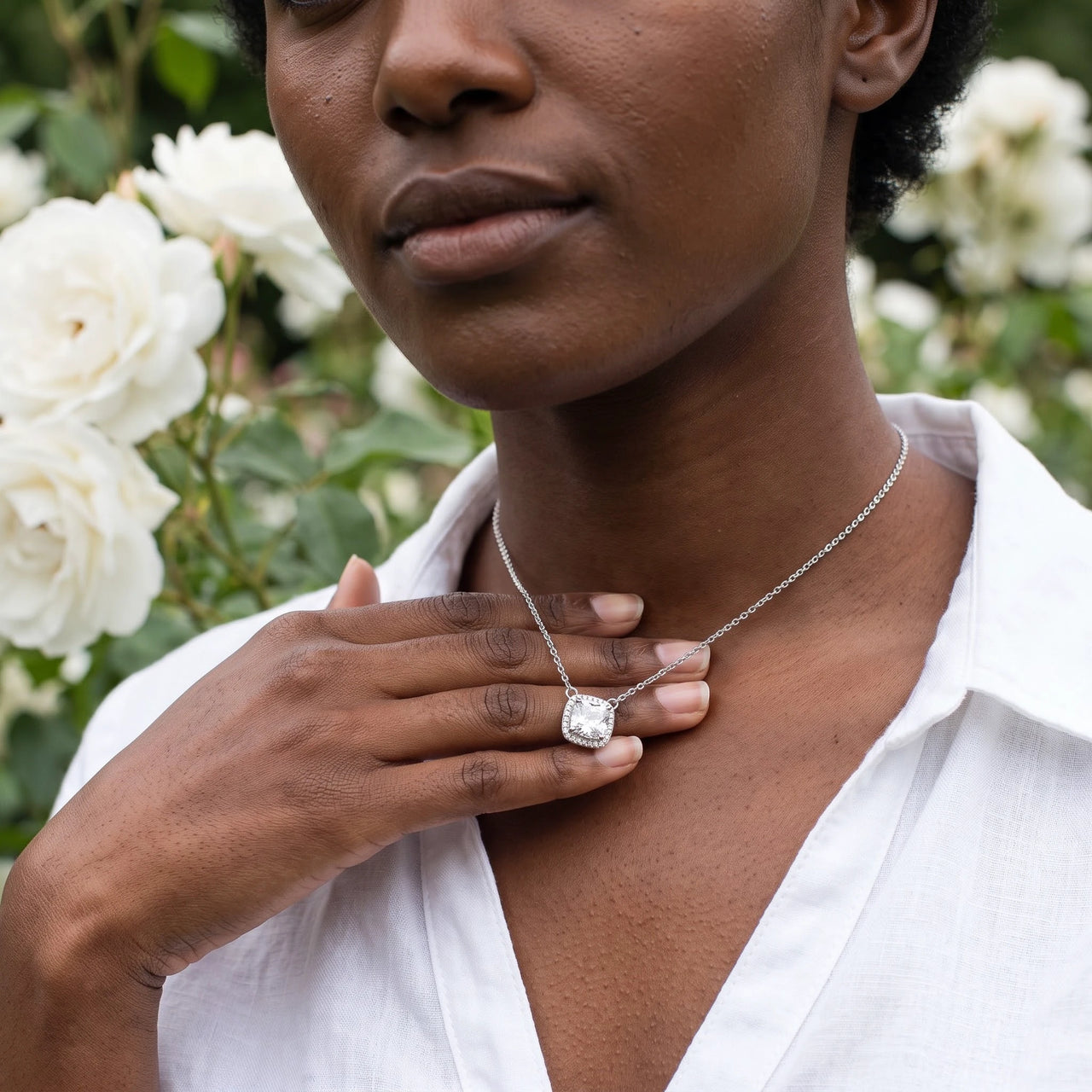Woman gently touching her silver necklace | SKU: 505721