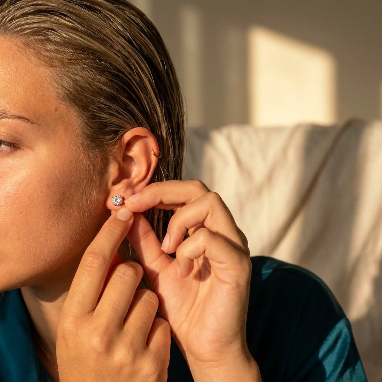 Solitaire Crystal Studs in Gold, being put on | SKU: 41010-gold