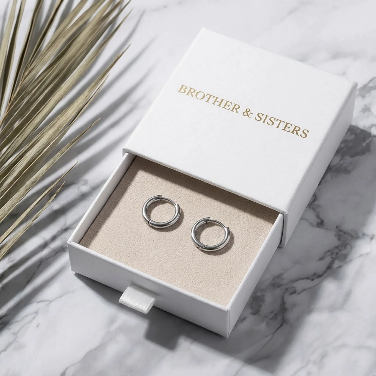 Tiny Huggie Hoops in Silver, in the gift box | SKU: 41002-silver